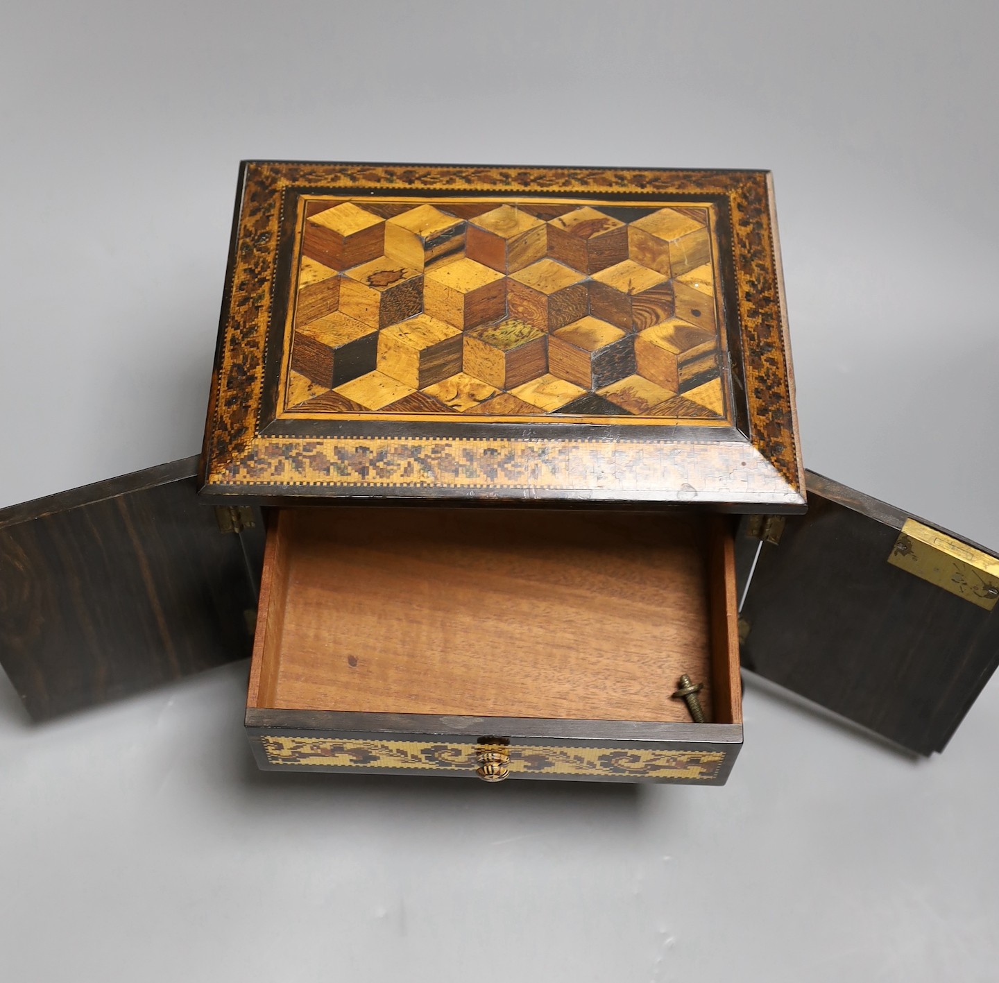 A 19th century Tunbridge ware specimen cube marquetry and coromandel table cabinet, label to underside reads ‘T.Barton, Late NYE, Manufacturer, Mount Ephraim and Parade, Tunbridge Wells’, 18cm tall